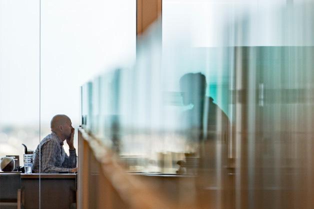 Abstract black and white image of man at desk with headphones.